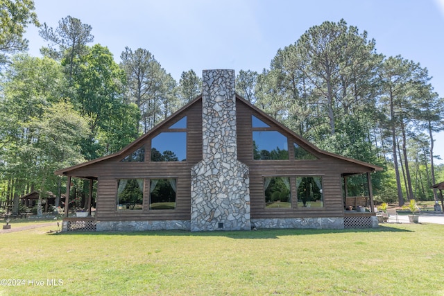 rear view of property with a lawn