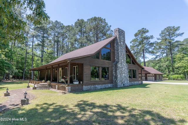 view of side of property with a garage, a lawn, and covered porch