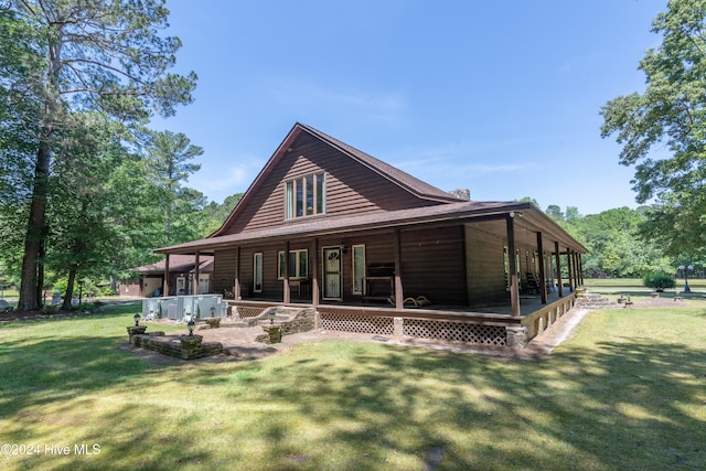 back of house with a lawn and covered porch