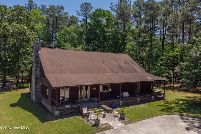 view of front of home featuring a patio area, french doors, and a front yard