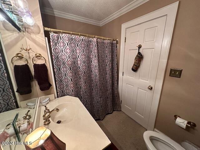 bathroom featuring ornamental molding, toilet, a textured ceiling, and sink