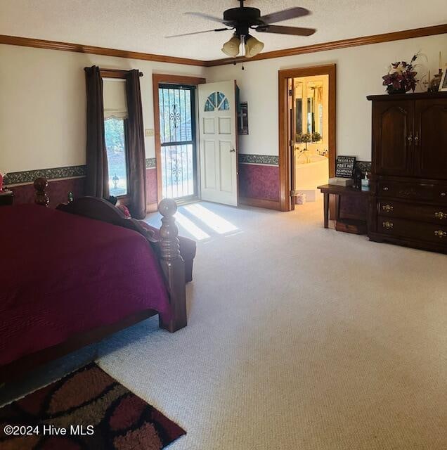 bedroom with a textured ceiling, light carpet, ceiling fan, and ensuite bathroom