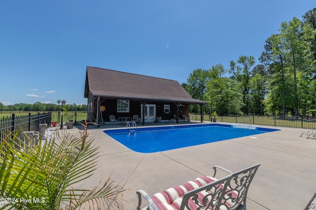 view of pool with an outbuilding and a patio area