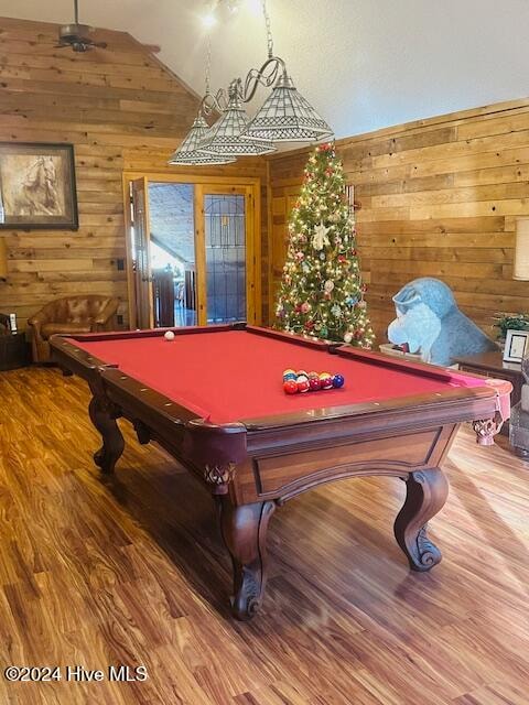 recreation room featuring wooden walls, lofted ceiling, wood-type flooring, and billiards