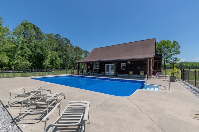 view of pool with ceiling fan and a patio area