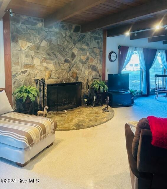 carpeted living room with wooden ceiling, beamed ceiling, and a fireplace