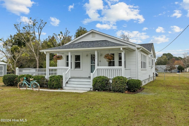 bungalow featuring a front lawn and a porch