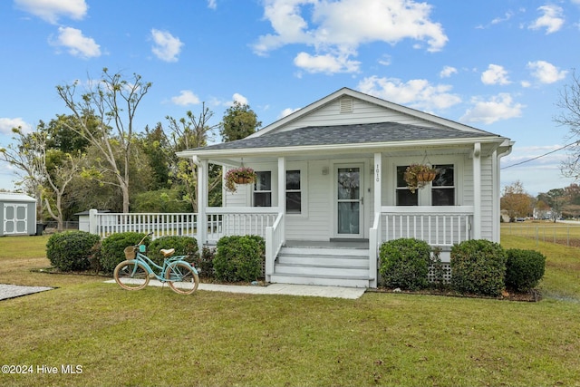 view of front of home featuring covered porch and a front lawn