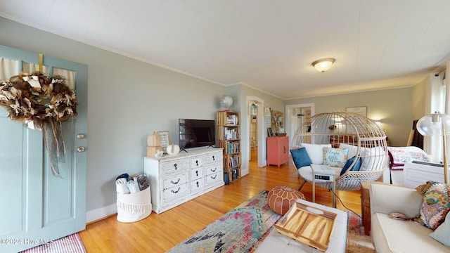 living room featuring light hardwood / wood-style flooring and ornamental molding