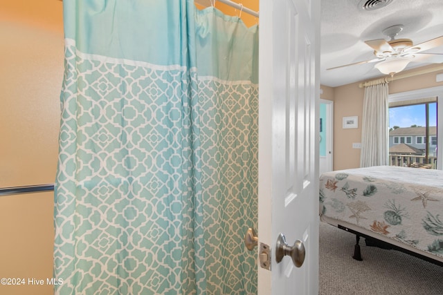 bedroom with a textured ceiling, ceiling fan, and carpet floors