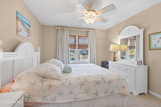 carpeted bedroom with multiple windows and ceiling fan