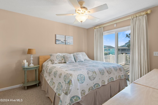 carpeted bedroom with ceiling fan and access to exterior