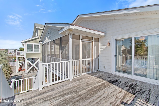 wooden terrace featuring a sunroom