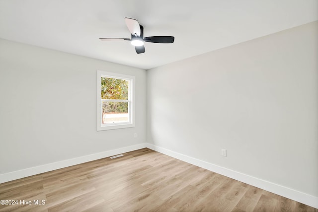 empty room with ceiling fan and light wood-type flooring