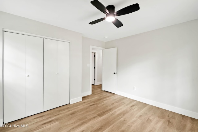 unfurnished bedroom featuring light wood-type flooring, a closet, and ceiling fan