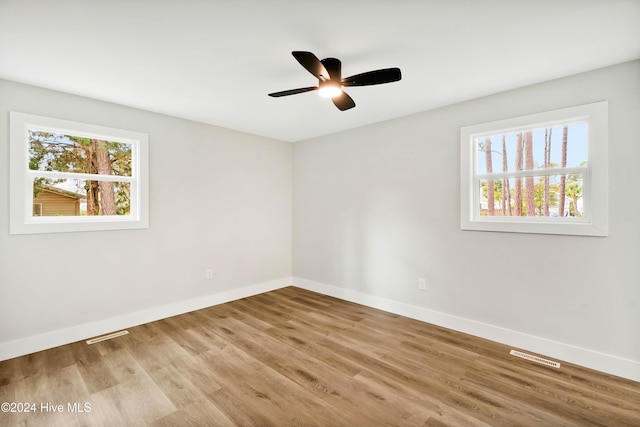 spare room with light hardwood / wood-style floors and ceiling fan