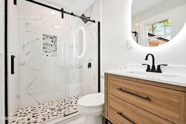 bathroom with vanity, toilet, and an enclosed shower