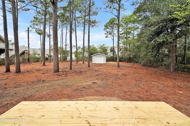 view of yard with a garage and an outbuilding