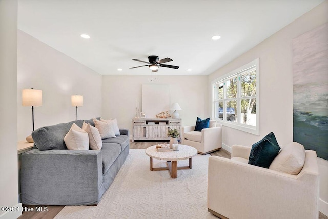 living room with light wood-type flooring and ceiling fan