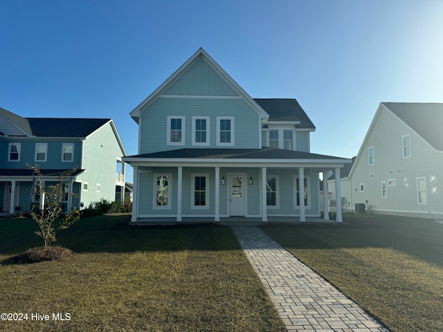 view of front facade with central AC, a front lawn, and covered porch