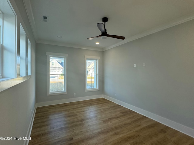 spare room with dark wood-type flooring, ceiling fan, and crown molding