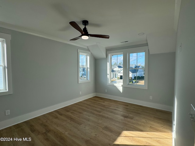 unfurnished room with light hardwood / wood-style floors, ceiling fan, and ornamental molding