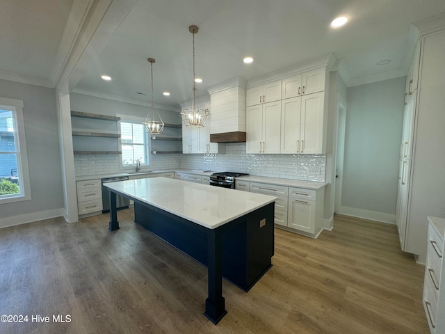 kitchen featuring dark wood-type flooring, white cabinetry, appliances with stainless steel finishes, and a center island