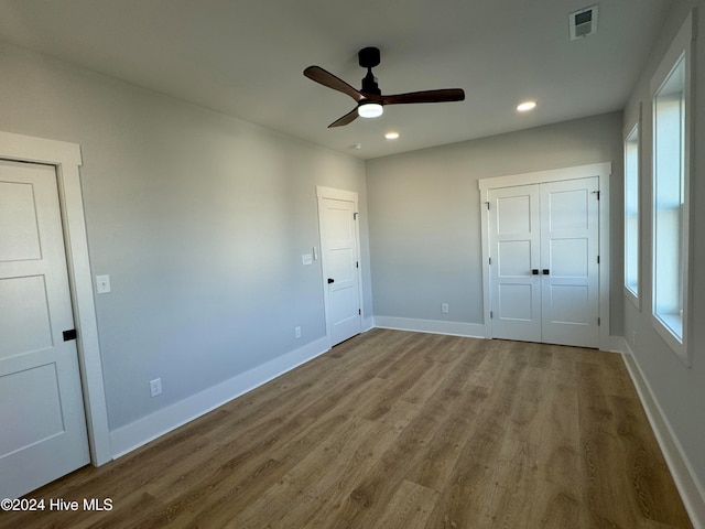 unfurnished bedroom featuring hardwood / wood-style floors and ceiling fan