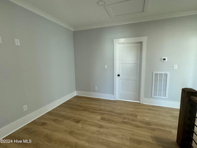 unfurnished room featuring ornamental molding and wood-type flooring