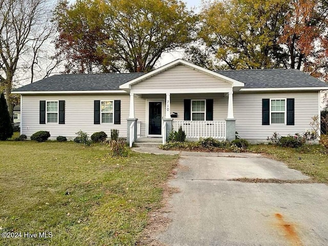 single story home with a porch and a front lawn