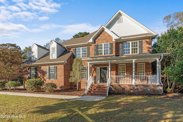 view of front facade featuring covered porch and a front lawn