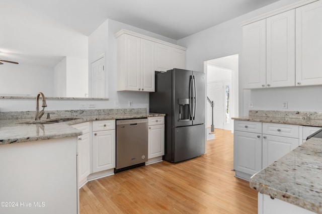 kitchen featuring white cabinets, appliances with stainless steel finishes, and sink