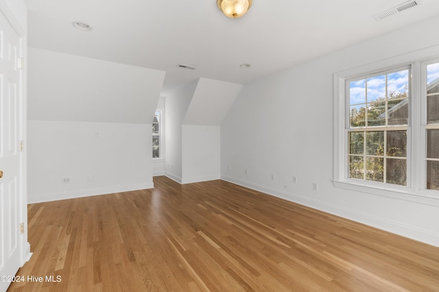 bonus room featuring hardwood / wood-style flooring and vaulted ceiling