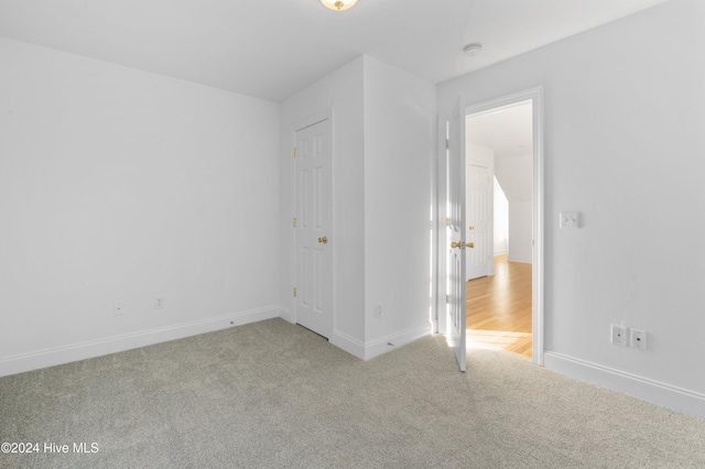 unfurnished bedroom featuring light colored carpet