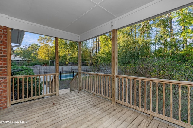 wooden deck featuring a swimming pool