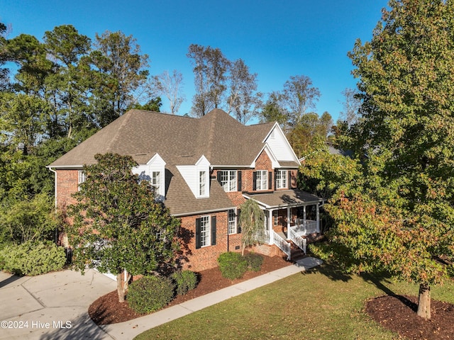 view of front of property with a front yard and a porch