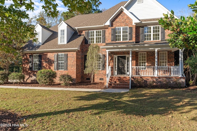 view of front facade featuring covered porch and a front yard