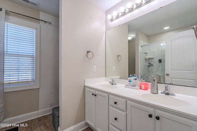 bathroom with an enclosed shower, wood-type flooring, a healthy amount of sunlight, and vanity