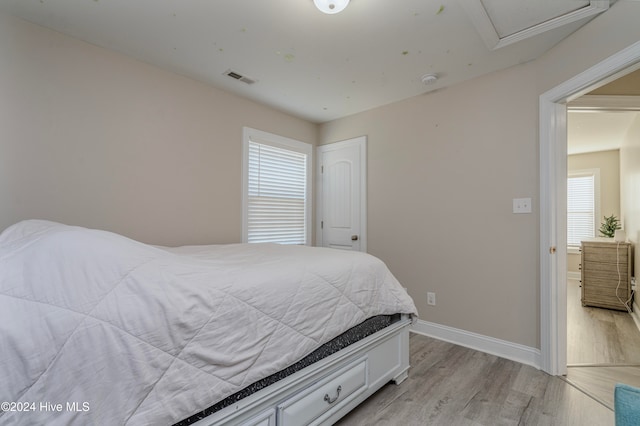 bedroom with light hardwood / wood-style floors