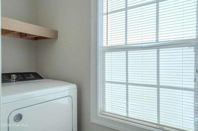 clothes washing area with washer / dryer