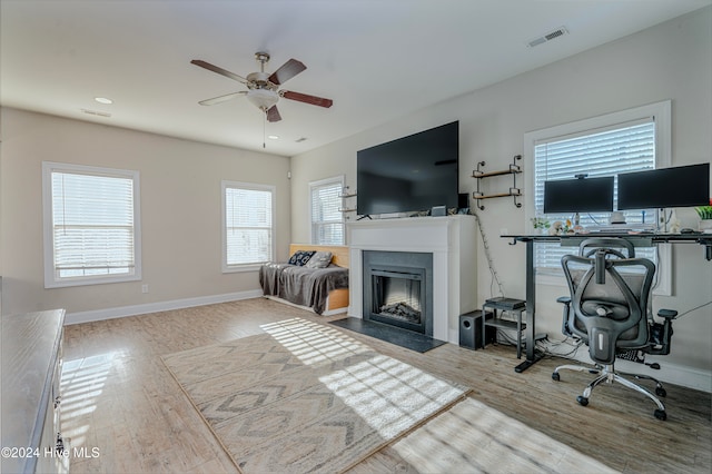 living room featuring hardwood / wood-style floors and ceiling fan