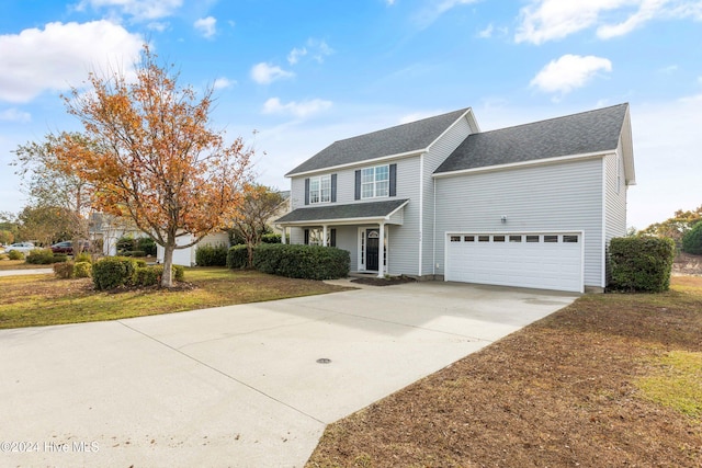 view of front of house with a garage and a front lawn