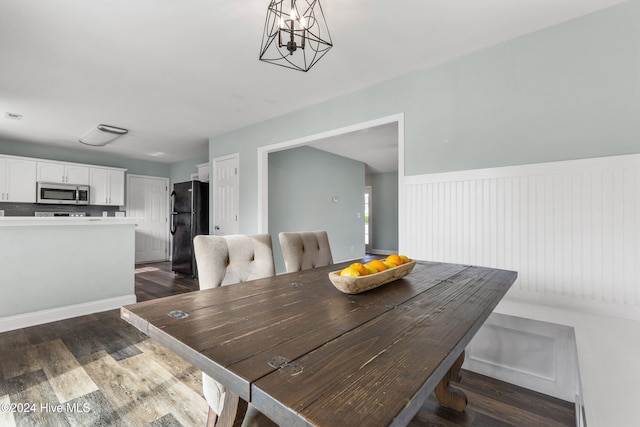 dining area featuring dark wood-type flooring