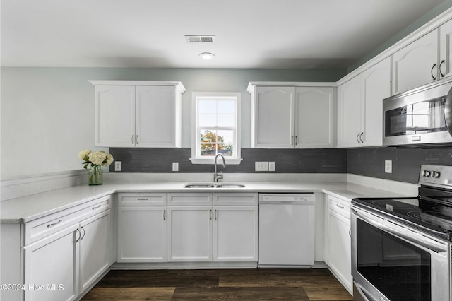 kitchen featuring sink, dark wood-type flooring, appliances with stainless steel finishes, tasteful backsplash, and white cabinets