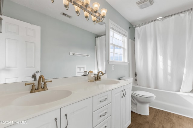 full bathroom featuring vanity, hardwood / wood-style floors, toilet, and shower / tub combo with curtain