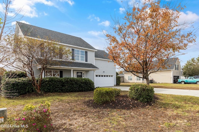 view of front facade featuring a front yard and a garage