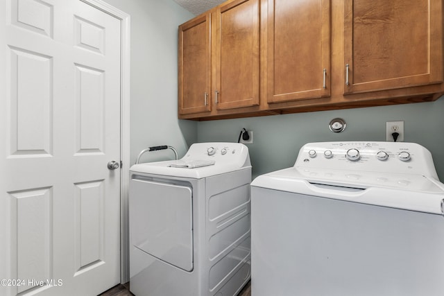 laundry room with cabinets and washer and clothes dryer