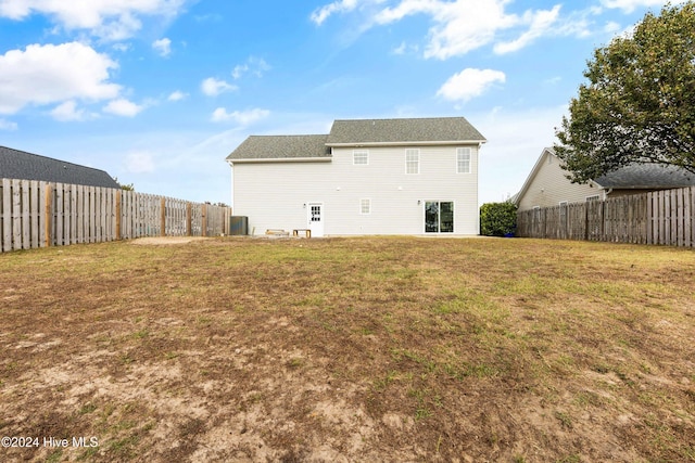 rear view of house featuring a lawn