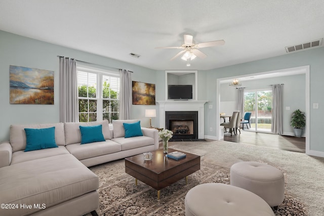 living room with carpet floors and ceiling fan