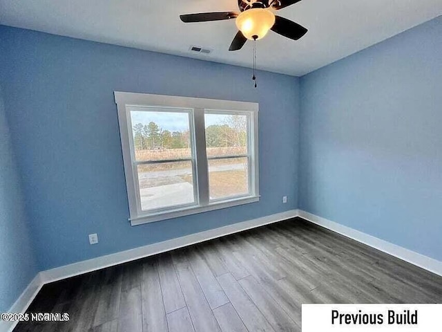 spare room with hardwood / wood-style flooring and ceiling fan